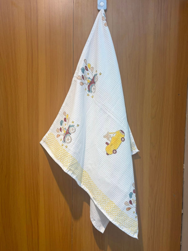 Benny’s Balloon Ride waffle handblock printed baby towel with bear and balloons – Newkasa.
Handblock printed waffle cotton baby towel featuring bear in car and balloons – Newkasa.
Jaipuri waffle baby towel with yellow car and balloon print – Newkasa.