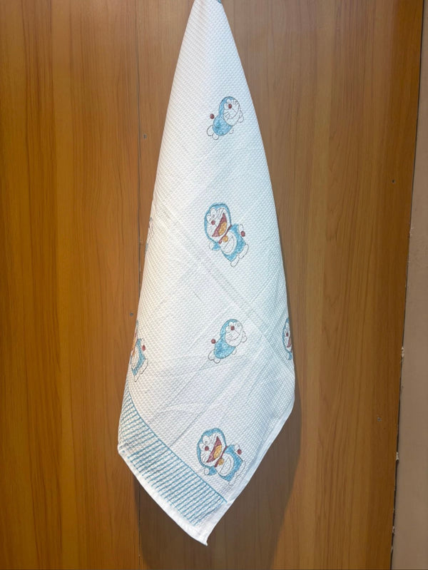 Dora’s Dreamland waffle handblock printed baby towel with blue cartoon character design – Newkasa.
Handblock printed waffle cotton baby towel featuring cute cartoon motifs – Newkasa.
Jaipuri waffle baby towel with blue and white character print and striped border – Newkasa.