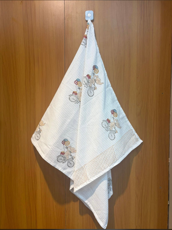 Ellie’s Balloon Ride waffle handblock printed baby towel with elephant and balloon motifs – Newkasa.
Handblock printed waffle cotton baby towel featuring elephant on bicycle design – Newkasa.
Jaipuri waffle baby towel with playful animal print and striped border – Newkasa.