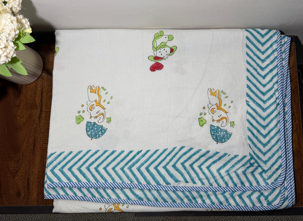 Baby blanket with cartoon designs on a wooden surface