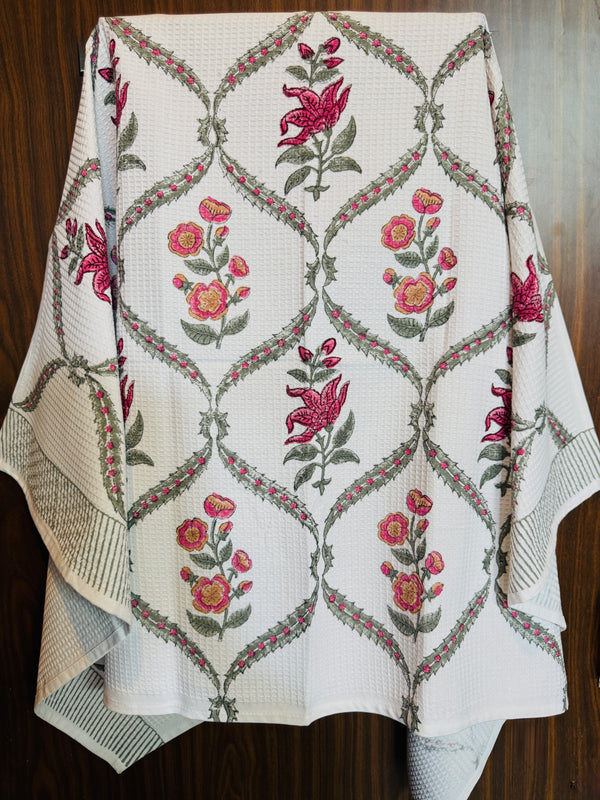 “Newkasa Amarbagh Jaipuri Hand Block Printed Cotton Waffle Bath Towel with pink and yellow floral motifs framed in sage vines, handcrafted in Jaipur Rajasthan — lightweight, absorbent 100% cotton towel for spa, home, and resort use.”