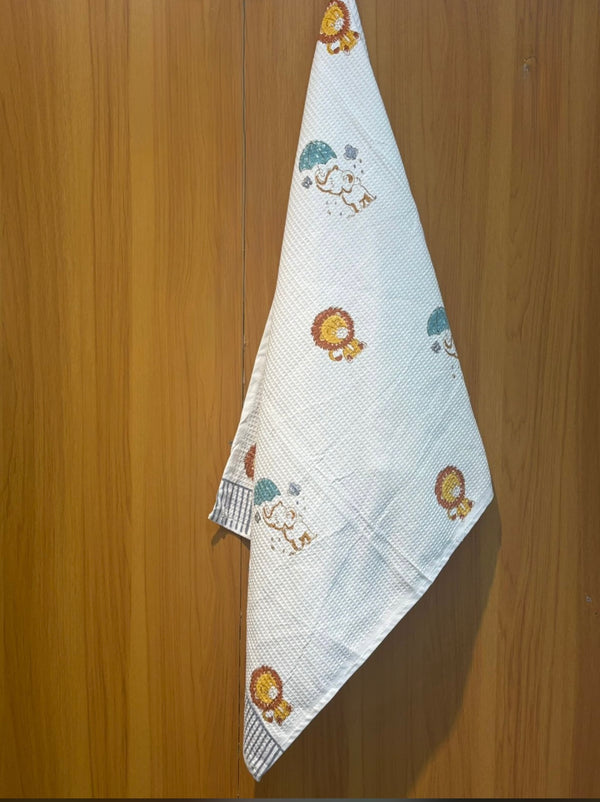 Lolo & Ellie’s Rainy Safari waffle handblock printed baby towel with lion and elephant motifs – Newkasa.

Handblock printed waffle cotton baby towel featuring jungle animals and umbrellas – Newkasa.

Jaipuri waffle baby towel with lion and elephant print and striped border – Newkasa.