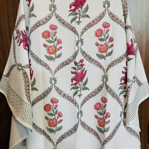 “Newkasa Amarbagh Jaipuri Hand Block Printed Cotton Waffle Bath Towel with pink and yellow floral motifs framed in sage vines, handcrafted in Jaipur Rajasthan — lightweight, absorbent 100% cotton towel for spa, home, and resort use.”