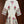 White robe with floral embroidery on a wooden background