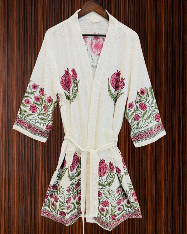 White robe with floral embroidery on a wooden background